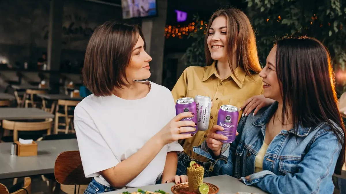 grupo-de-amigas-sosteniendo-latas-de-hidraya-agua-enriquecida